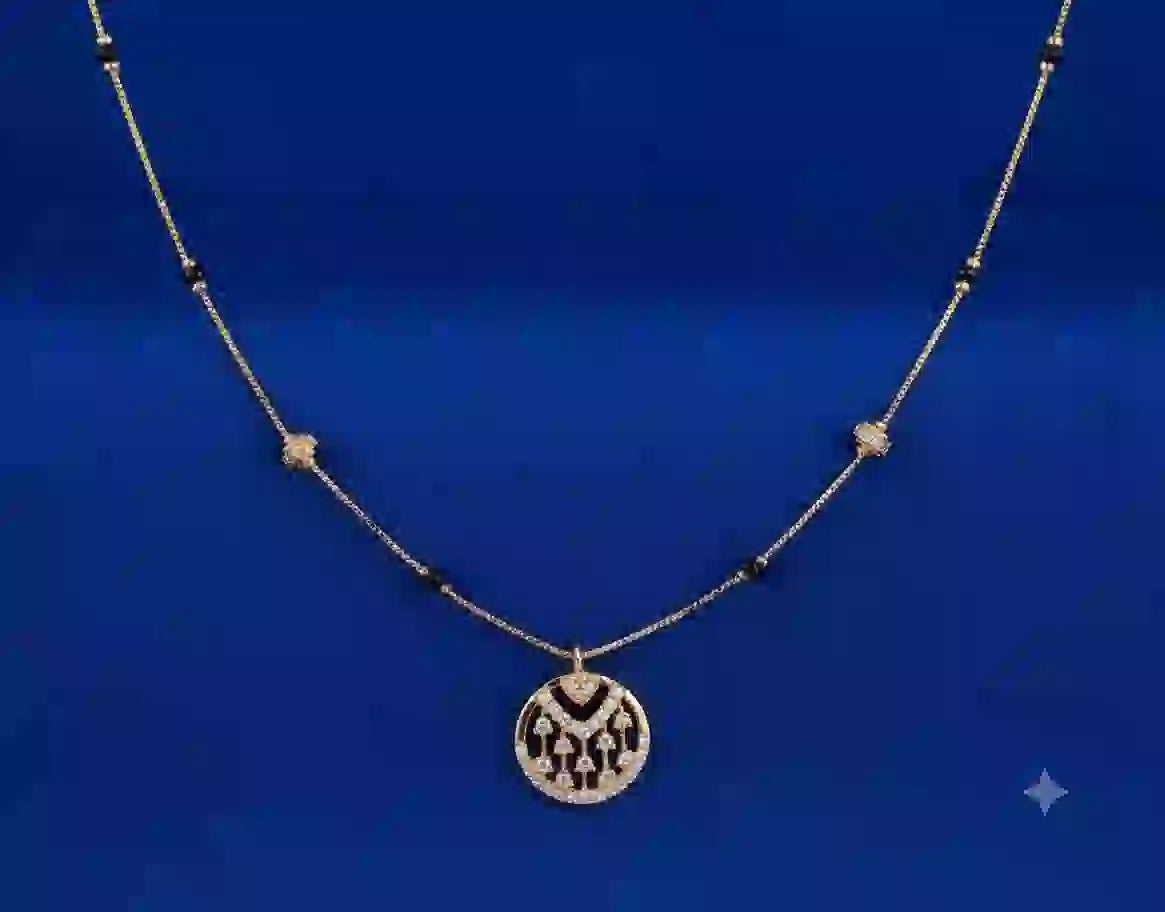 Gold mangalsutra with black beads and circular pendant on blue background
