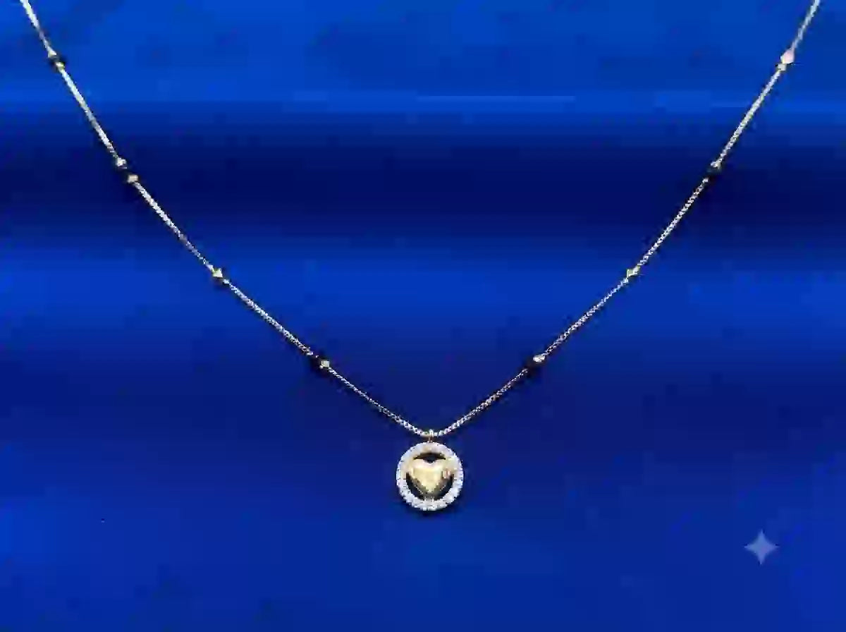 Golden Heart Circle Pendant Necklace on blue satin background