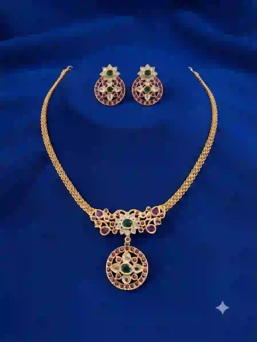 Kundan necklace set with matching circular earrings on blue velvet background
